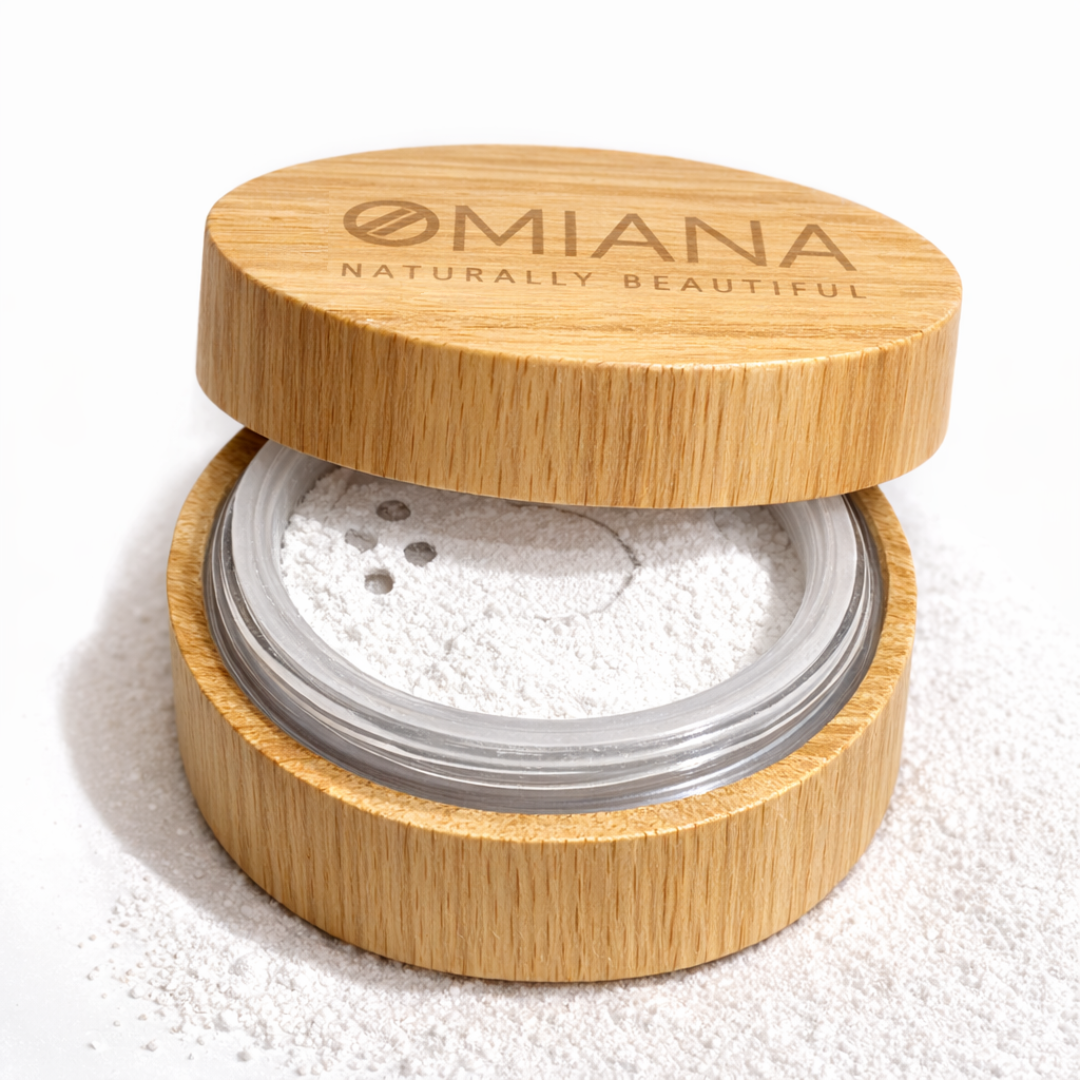 Open wooden container of Omiana Mineral Veil finishing powder titanium dioxide-free mineral makeup in  Bamboo container with white powder on a white background